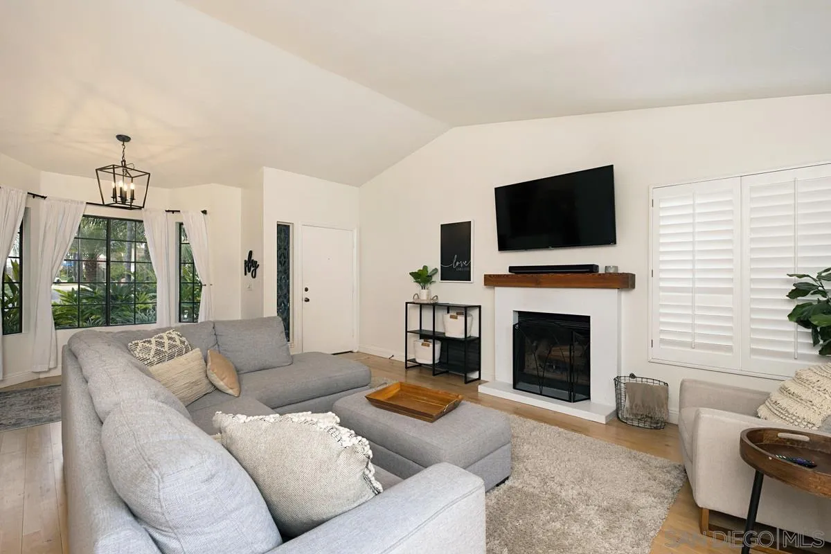 1265 Longfellow Road Vista, CA 92081 - Photo 7 of 28 a living room with furniture a fireplace and a flat screen tv
