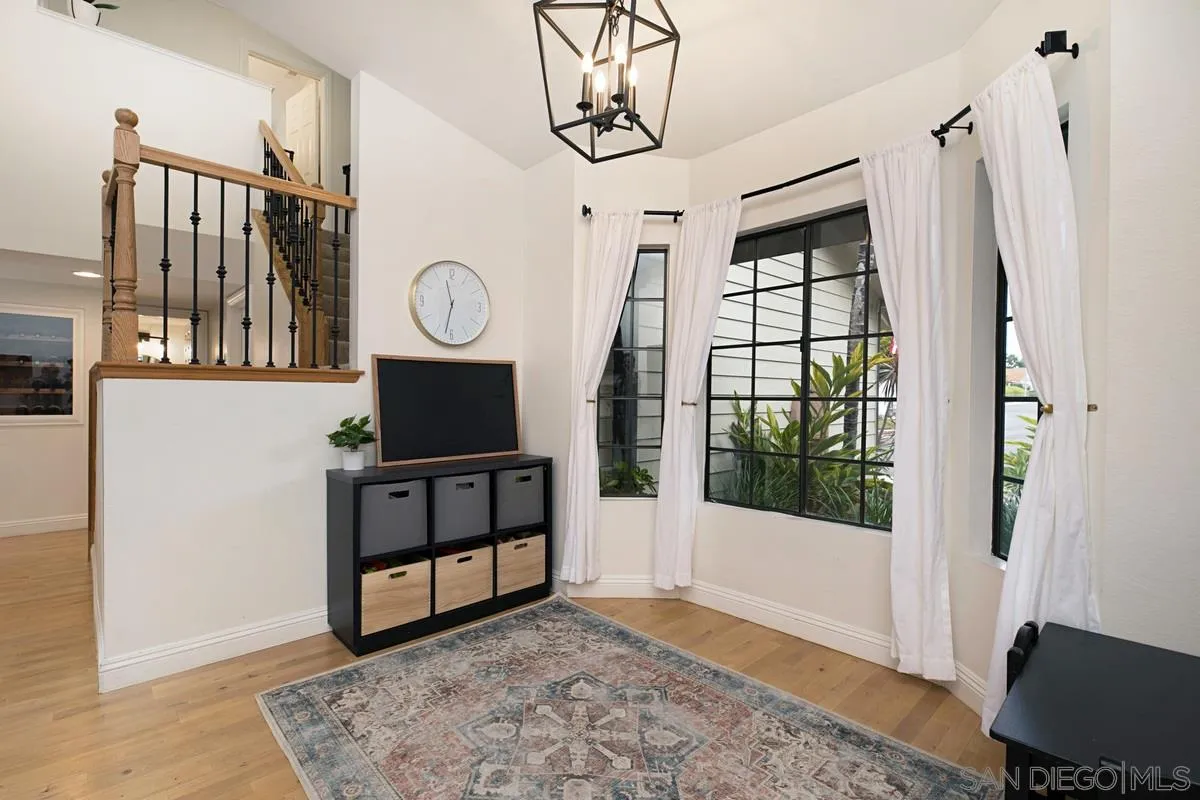 1265 Longfellow Road Vista, CA 92081 - Photo 9 of 28 a view of a hallway with entryway wooden floor and front door