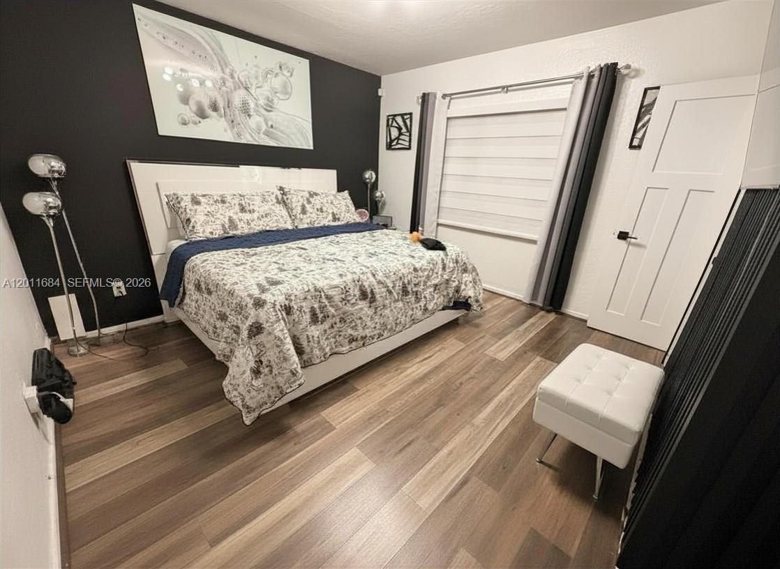 315 West 62nd Street Hialeah, FL 33012 - Photo 16 of 21 a bed sitting in a bedroom next to a window