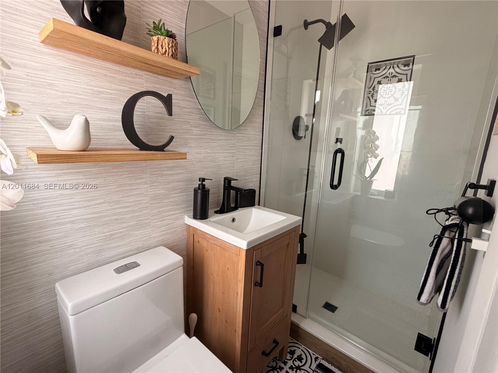 315 West 62nd Street Hialeah, FL 33012 - Photo 17 of 21 a bathroom with a sink a toilet and a mirror