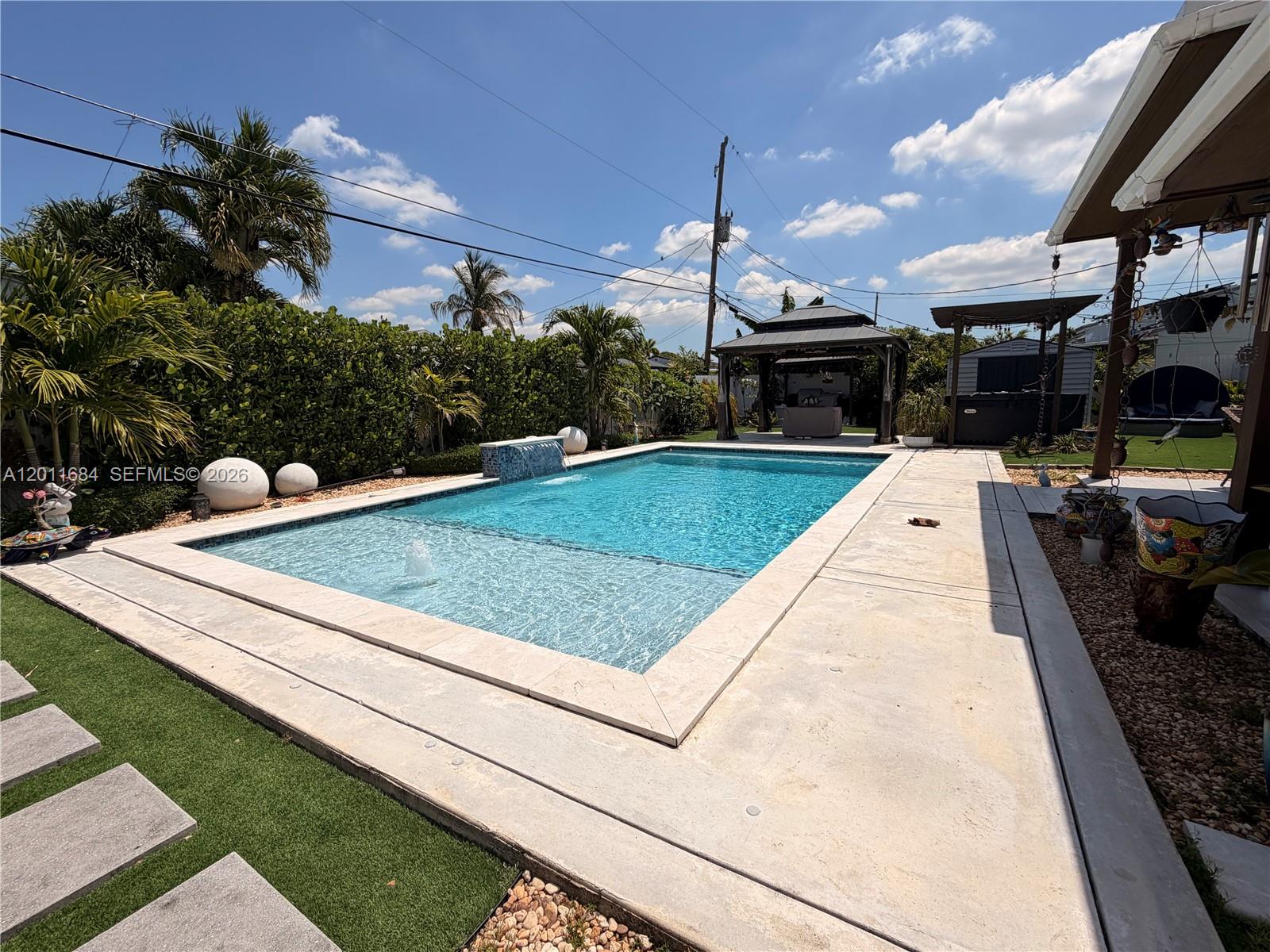 315 West 62nd Street Hialeah, FL 33012 - Photo 2 of 21 a view of a swimming pool with a patio