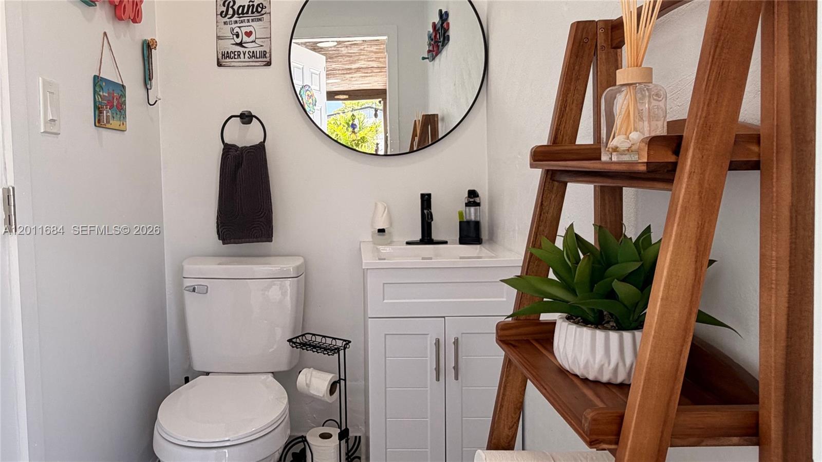 315 West 62nd Street Hialeah, FL 33012 - Photo 21 of 21 a bathroom with a toilet sink and mirror