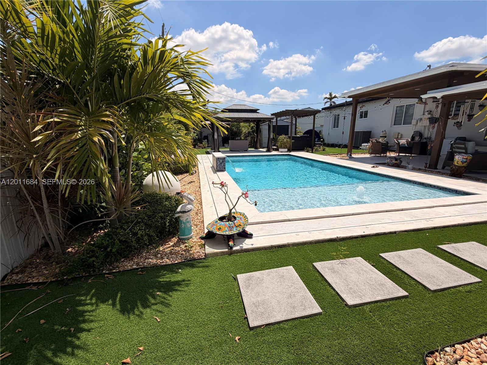315 West 62nd Street Hialeah, FL 33012 - Photo 6 of 21 a view of a house with swimming pool and sitting area