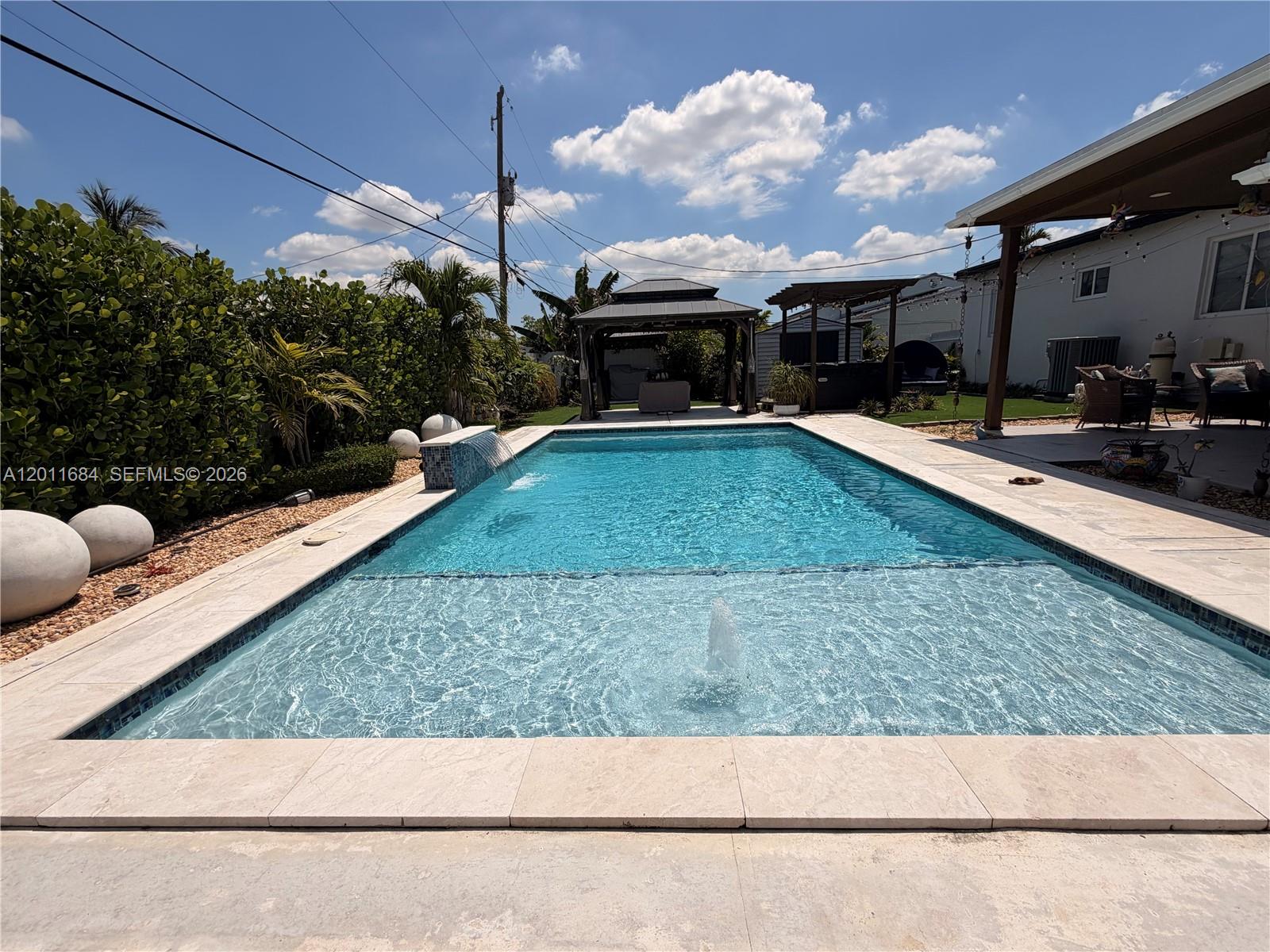 315 West 62nd Street Hialeah, FL 33012 - Photo 7 of 21 a view of a backyard with plants and a patio