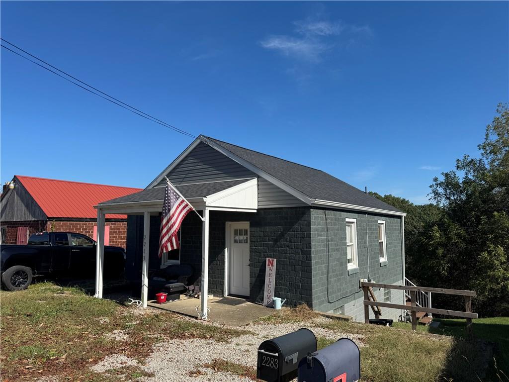 a patio with a table and chairs under an umbrella