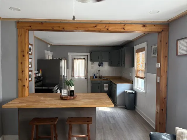 a kitchen with kitchen island a sink stainless steel appliances and cabinets