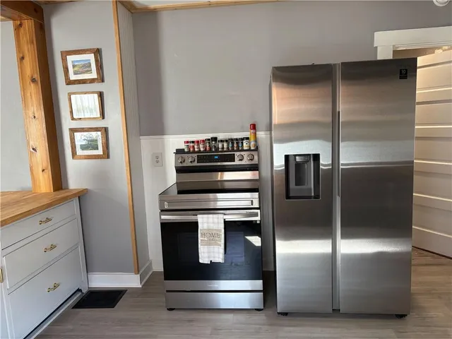 a kitchen with granite countertop a refrigerator and a stove