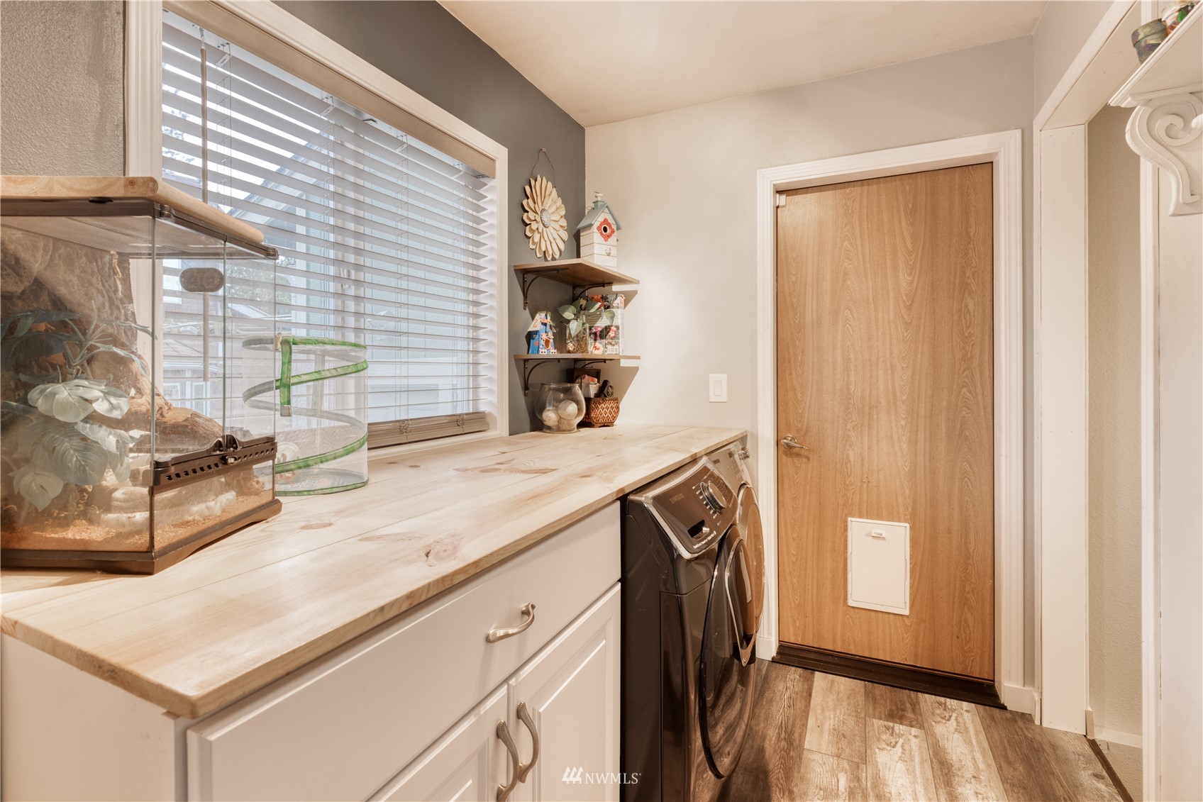 7414 Vandermark Road East Bonney Lake, WA 98391 - Photo 16 of 40 a kitchen with stainless steel appliances granite countertop a sink and a refrigerator