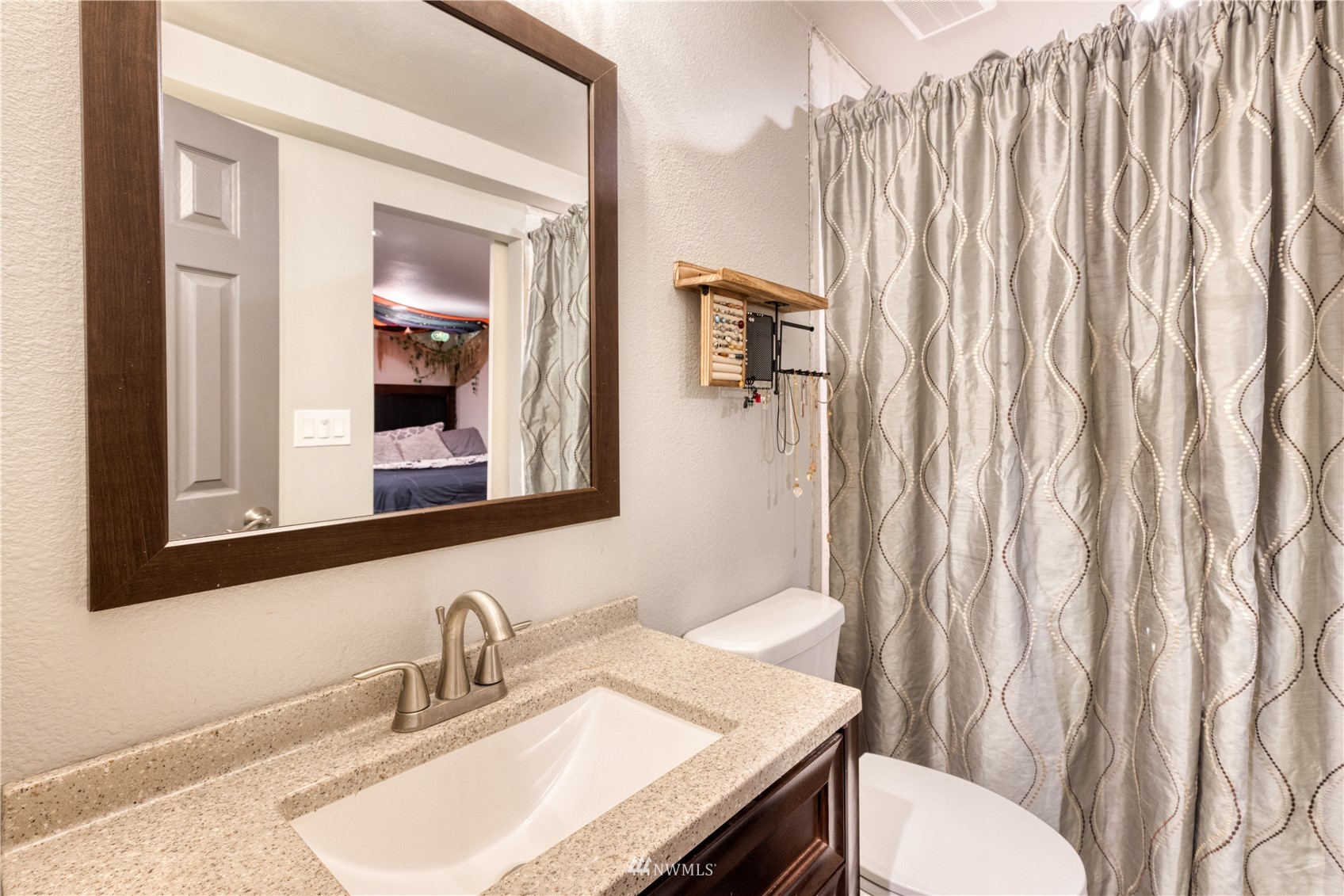 7414 Vandermark Road East Bonney Lake, WA 98391 - Photo 20 of 40 a bathroom with a granite countertop sink and a mirror with toilet