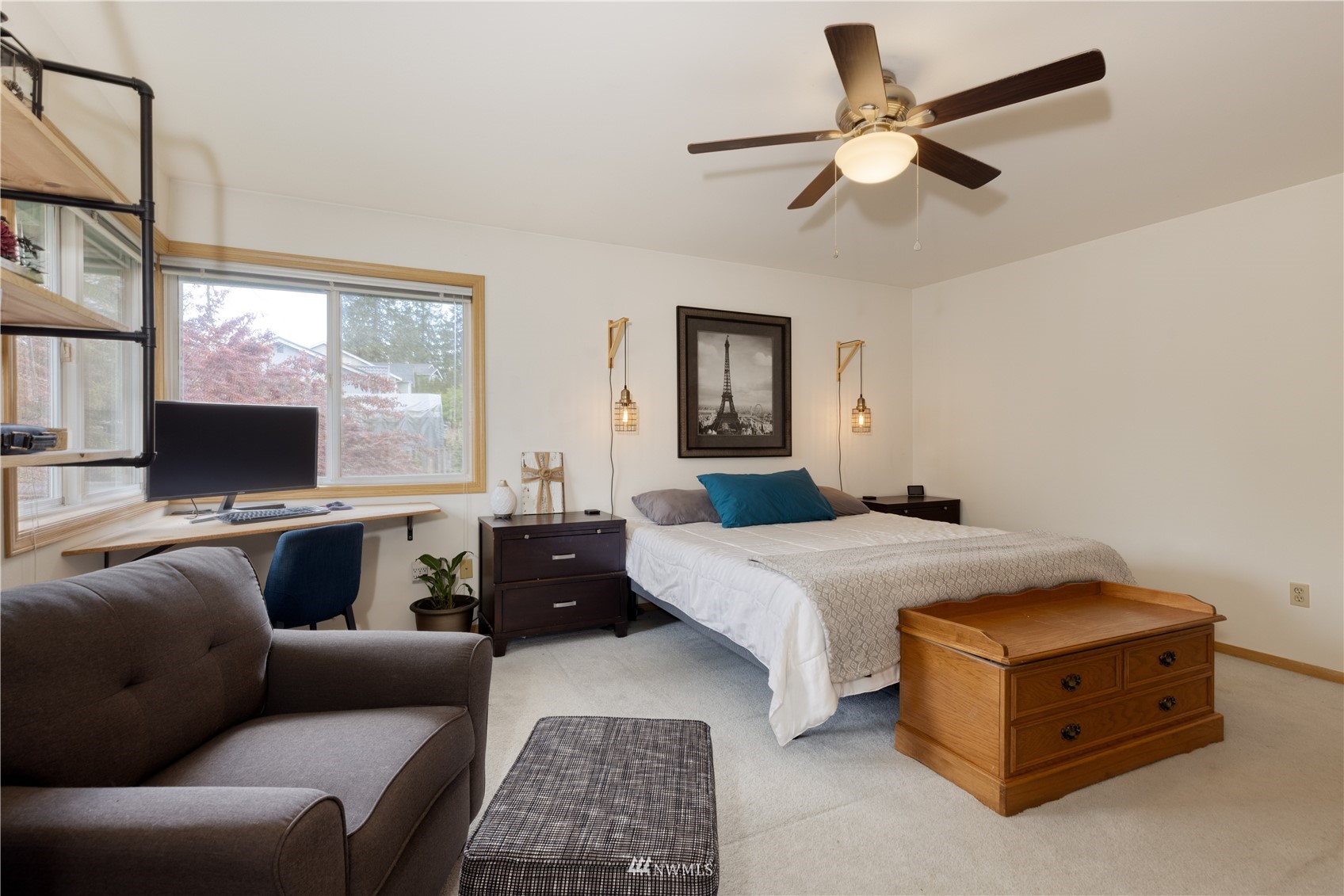 7414 Vandermark Road East Bonney Lake, WA 98391 - Photo 24 of 40 a bedroom with a bed a couch and a flat screen tv
