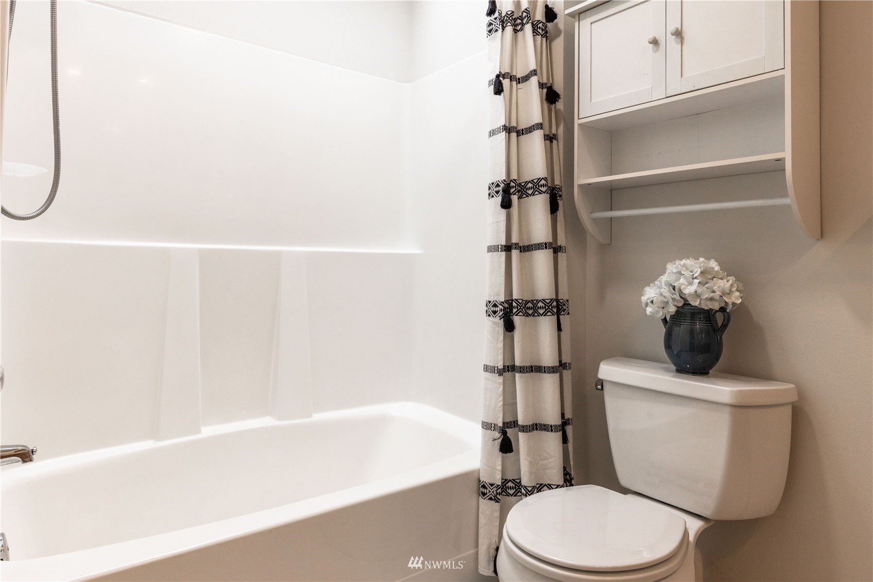 7414 Vandermark Road East Bonney Lake, WA 98391 - Photo 27 of 40 a white toilet sitting next to a bath tub and a shower