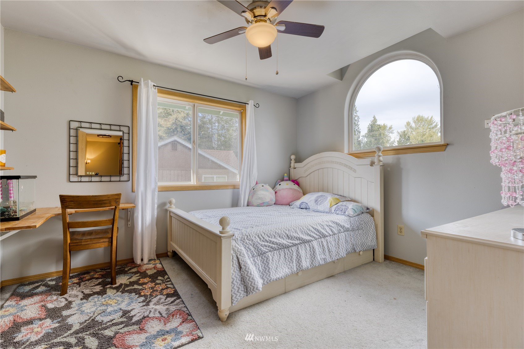 7414 Vandermark Road East Bonney Lake, WA 98391 - Photo 28 of 40 a bedroom with a bed and a chandelier