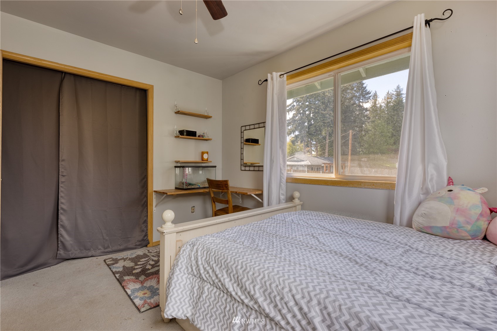 7414 Vandermark Road East Bonney Lake, WA 98391 - Photo 29 of 40 a bedroom with a large bed and a window