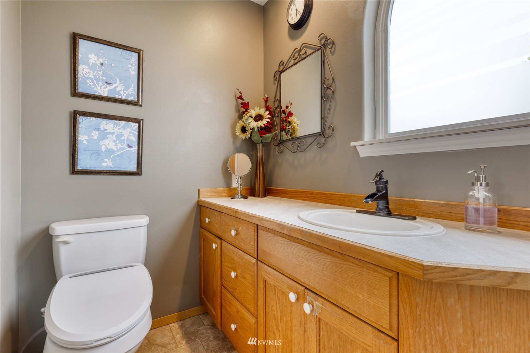 7414 Vandermark Road East Bonney Lake, WA 98391 - Photo 32 of 40 a bathroom with a toilet a sink and mirror