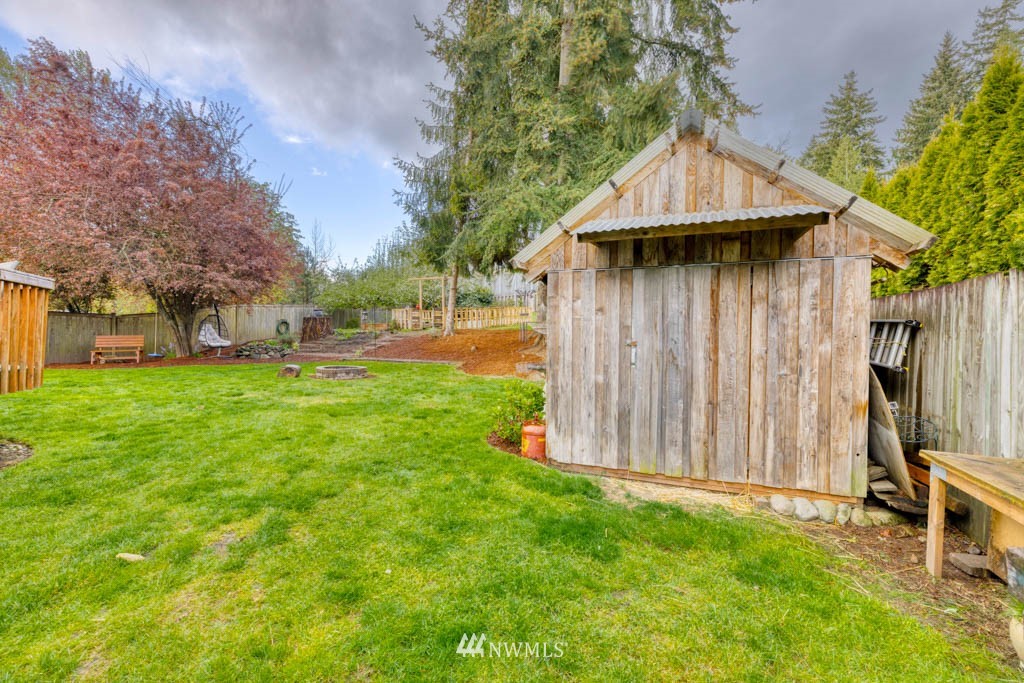 7414 Vandermark Road East Bonney Lake, WA 98391 - Photo 36 of 40 a backyard of a house with table and chairs