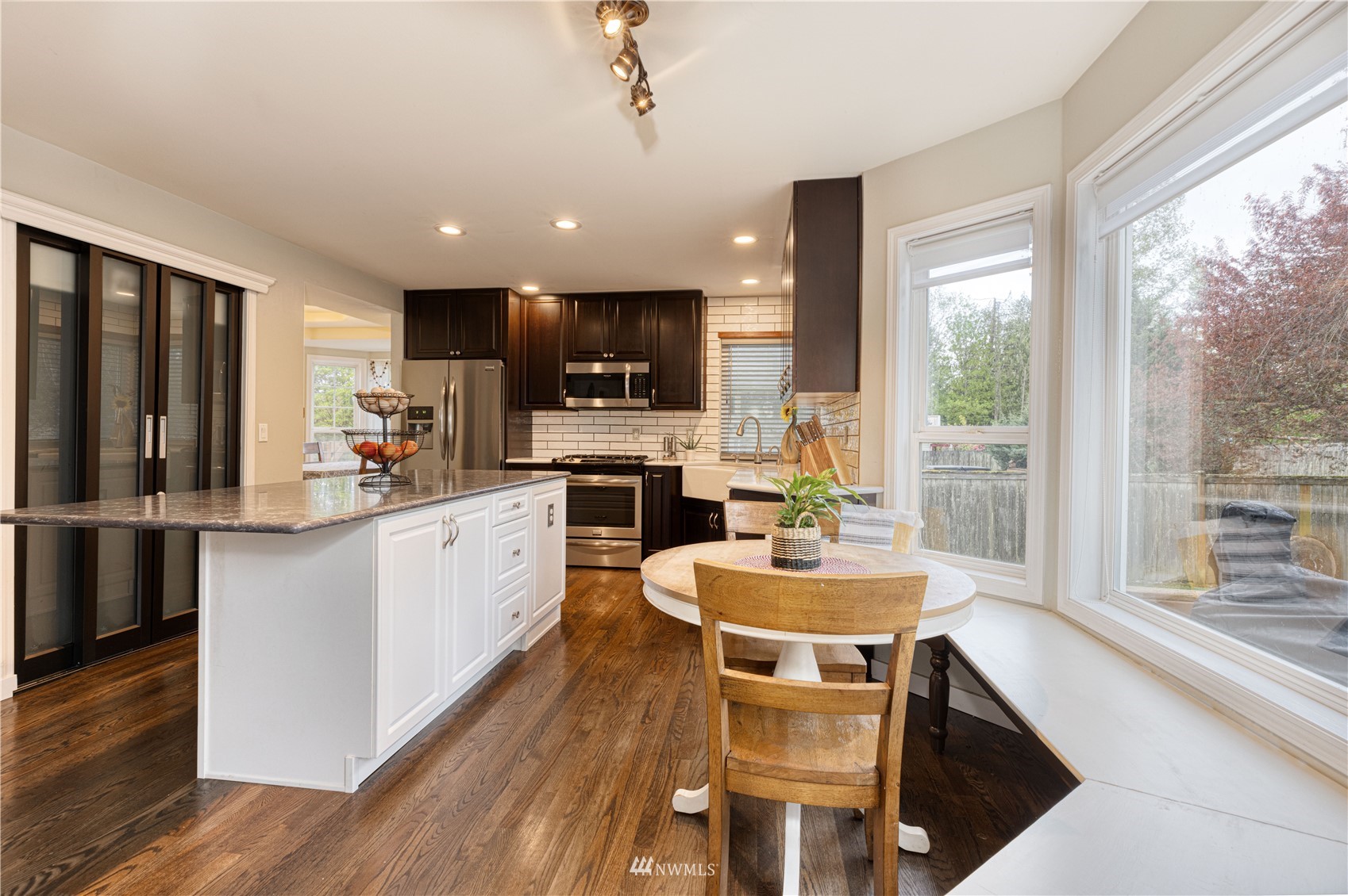 7414 Vandermark Road East Bonney Lake, WA 98391 - Photo 8 of 40 a kitchen with kitchen island a large counter top space appliances and cabinets