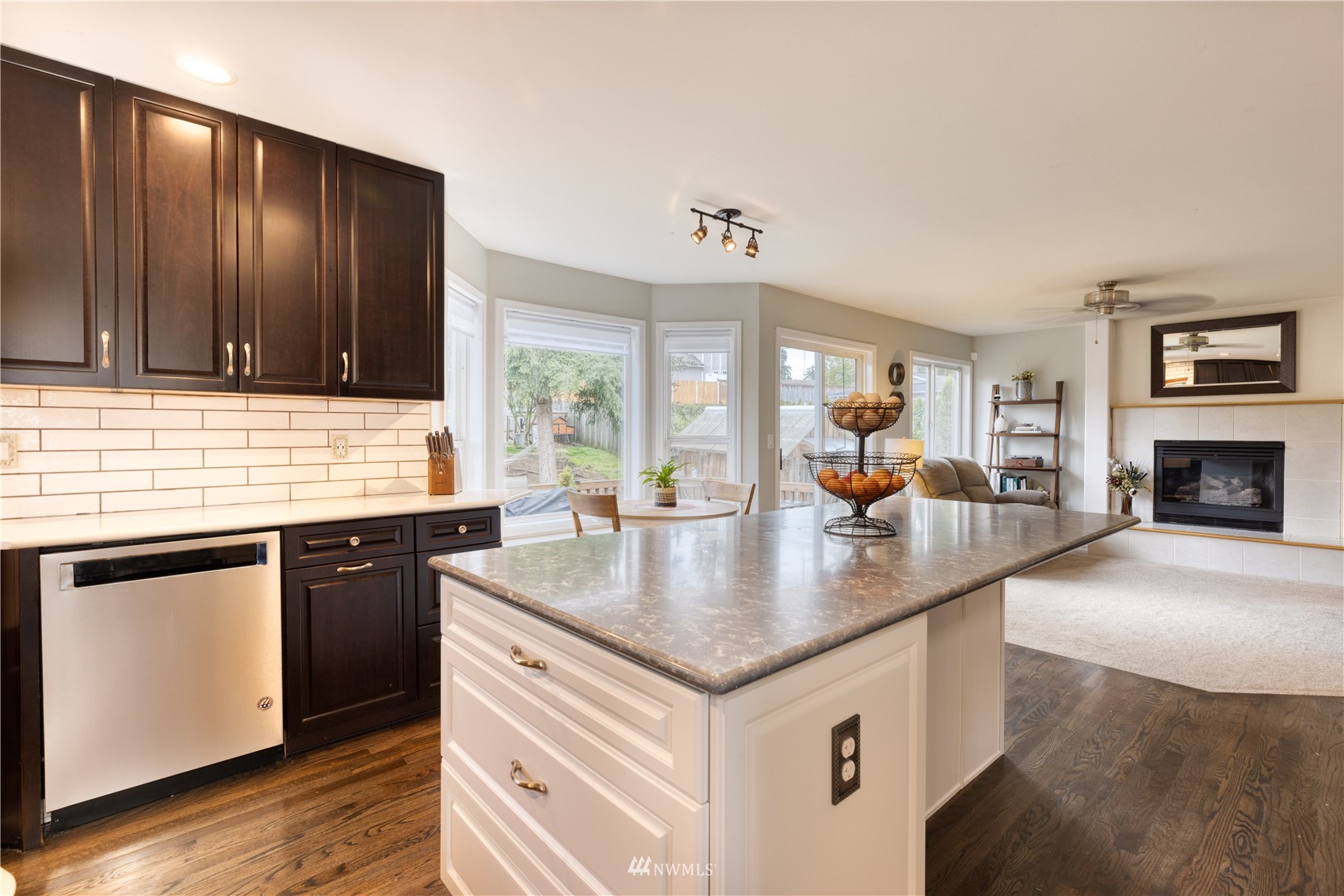 7414 Vandermark Road East Bonney Lake, WA 98391 - Photo 10 of 40 a kitchen with a cabinets counter top space and a fireplace