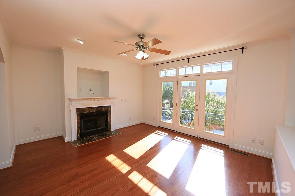 6111 Shandwick Court Raleigh, NC 27609 - Photo 2 of 17 a view of an empty room with a fireplace and a window