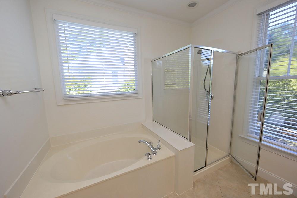 6111 Shandwick Court Raleigh, NC 27609 - Photo 11 of 17 a white bath tub sitting next to a shower