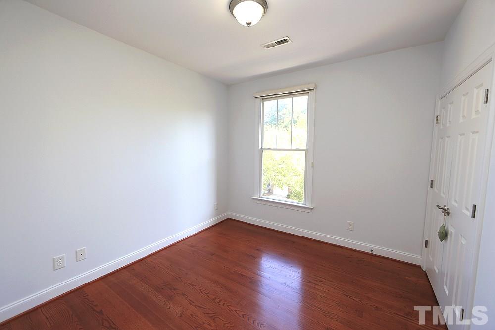 6111 Shandwick Court Raleigh, NC 27609 - Photo 14 of 17 an empty room with wooden floor and windows