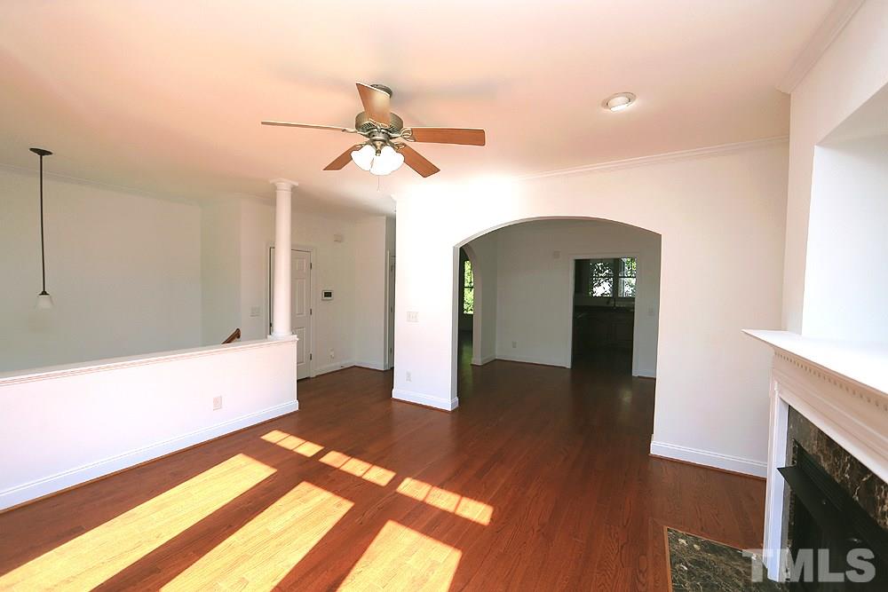 6111 Shandwick Court Raleigh, NC 27609 - Photo 3 of 17 a view of an empty room and window with wooden floor