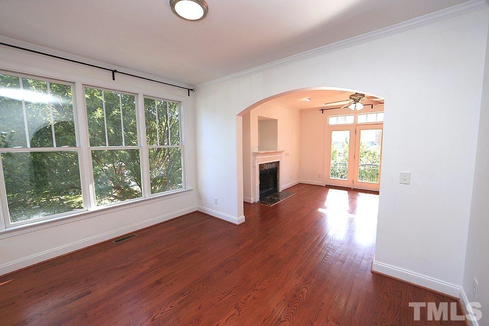 6111 Shandwick Court Raleigh, NC 27609 - Photo 4 of 17 a view of empty room with wooden floor and fan