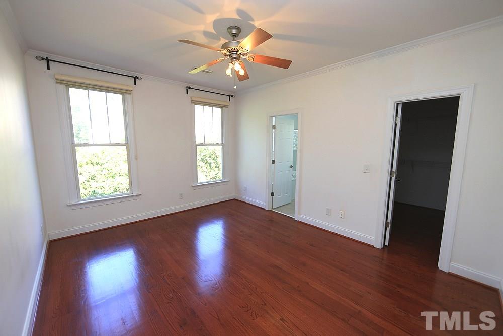 6111 Shandwick Court Raleigh, NC 27609 - Photo 9 of 17 a view of an empty room with wooden floor and a window