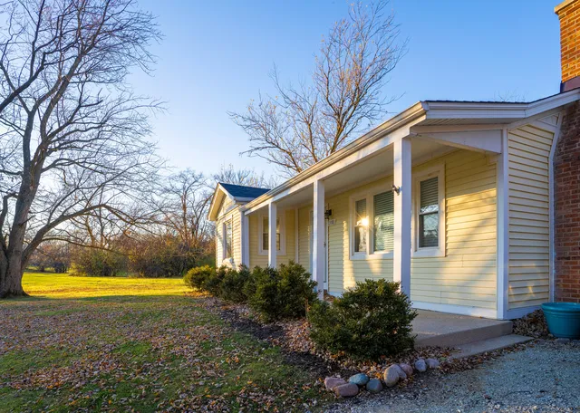 a view of empty room with wooden floor and fireplace