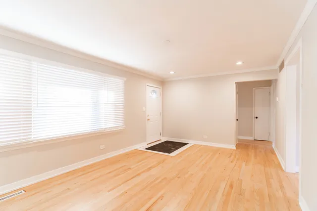 an empty room with a fireplace and windows