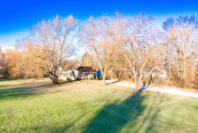 a view of residential houses with yard and swimming pool