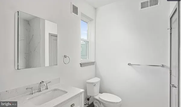 a bathroom with a sink toilet and vanity