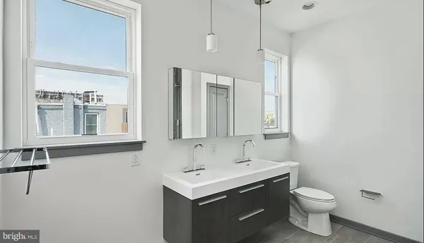 a bathroom with a sink toilet and mirror