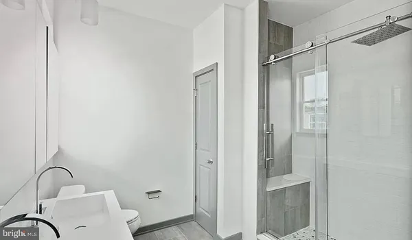 a bathroom with a sink and shower