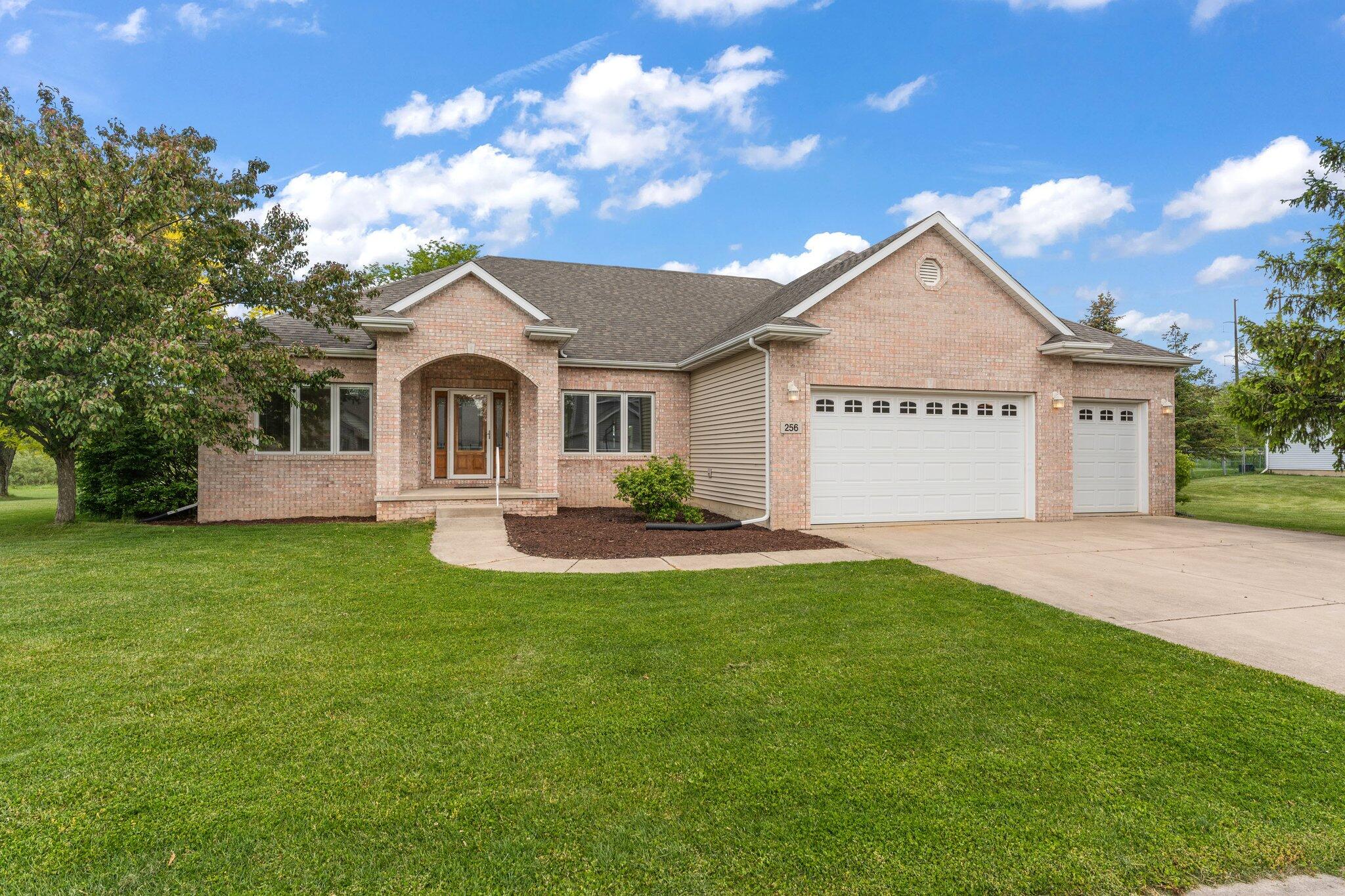 256 Pineview Lane Valparaiso, IN 46383 - Photo 1 of 18 a front view of a house with a garden and yard