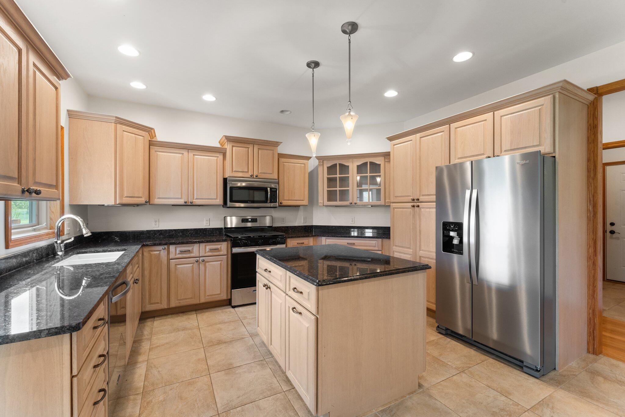 256 Pineview Lane Valparaiso, IN 46383 - Photo 7 of 18 a kitchen with granite countertop appliances cabinets and a sink