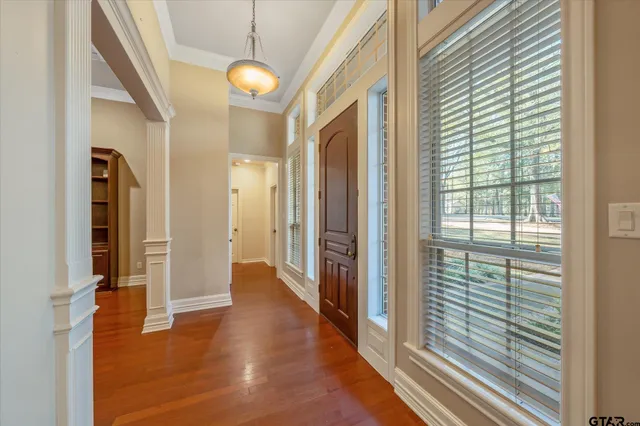 a view of a hallway with wooden floor and staircase