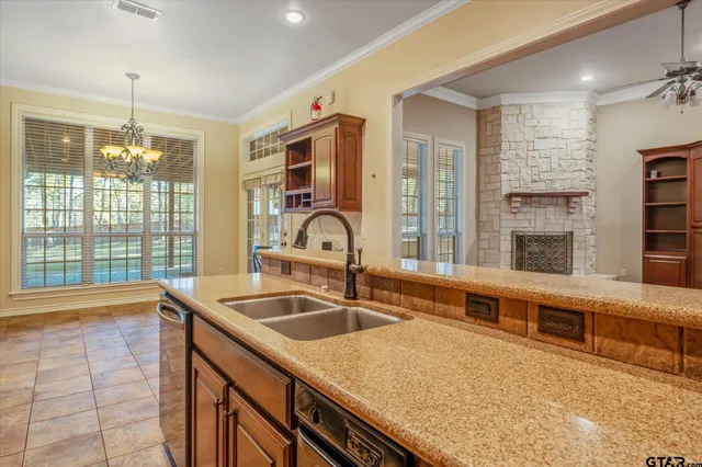 a kitchen with granite countertop a sink and a refrigerator
