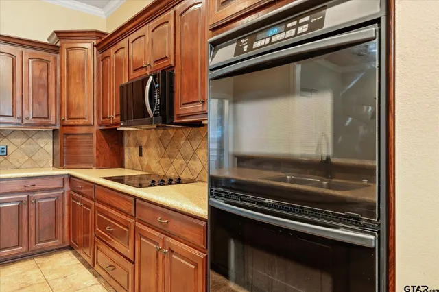 a kitchen with wooden cabinets and a stove top oven