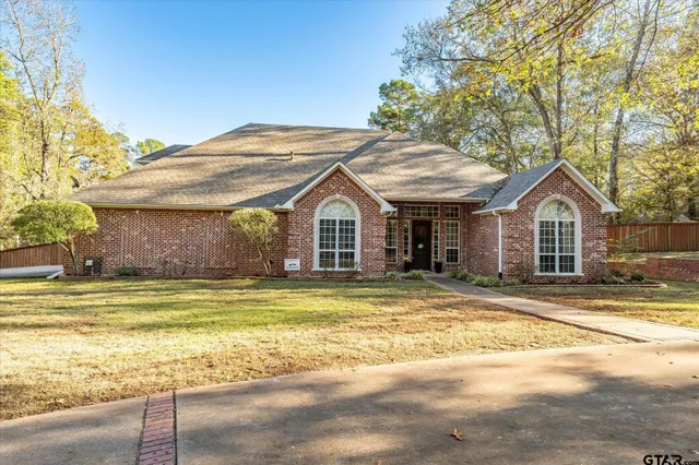 a view of a house with a swimming pool and sitting area