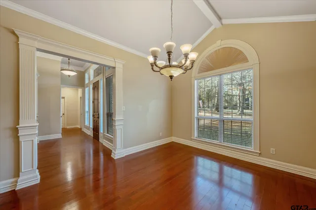 a view of a livingroom with wooden floor and a large window