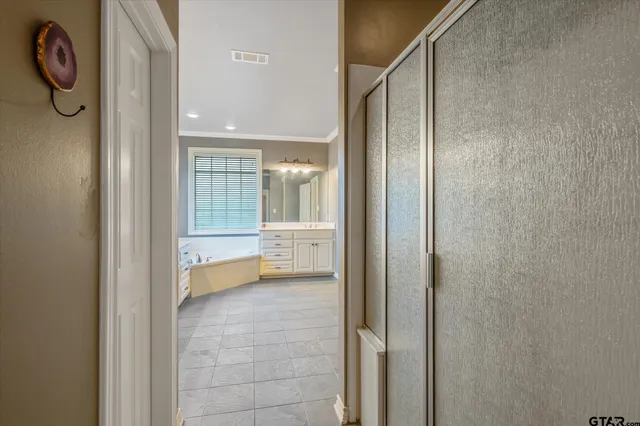 a bathroom with a glass shower door and a sink