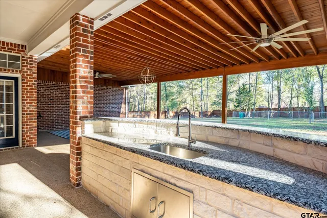 a kitchen with granite countertop a sink and a wooden floor