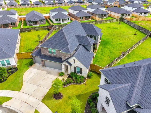 an aerial view of residential houses with outdoor space and swimming pool
