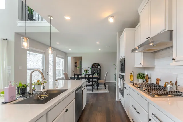 a kitchen with counter top space a sink stainless steel appliances and cabinets