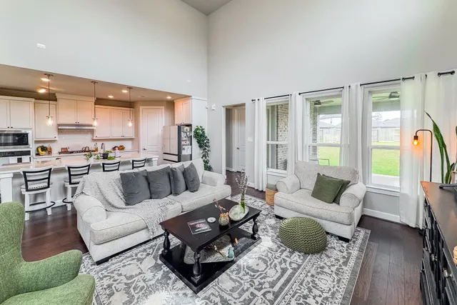 a living room with furniture and wooden floor