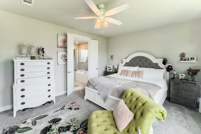 a large spacious bathroom with a double vanity sink and mirror