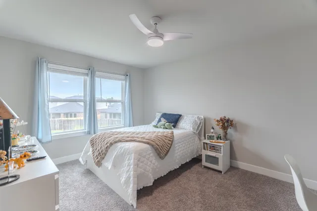 a bedroom with a bed and a table in it