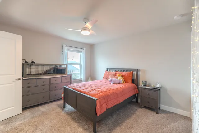 a bedroom with a bed and a night stand