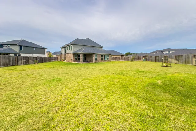 an aerial view of a house with a garden and a swimming pool