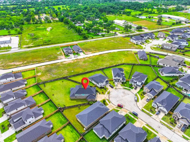 a aerial view of a house with a yard table and chairs